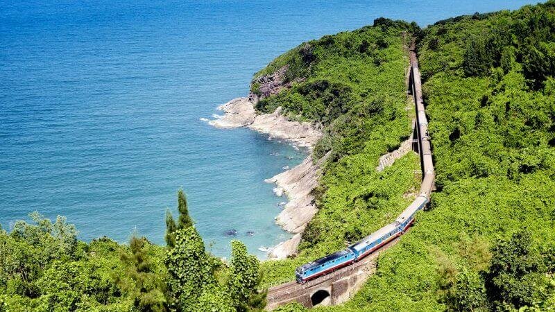 The Reunification Express train runs along the East Sea, north of the Hai Van Pass